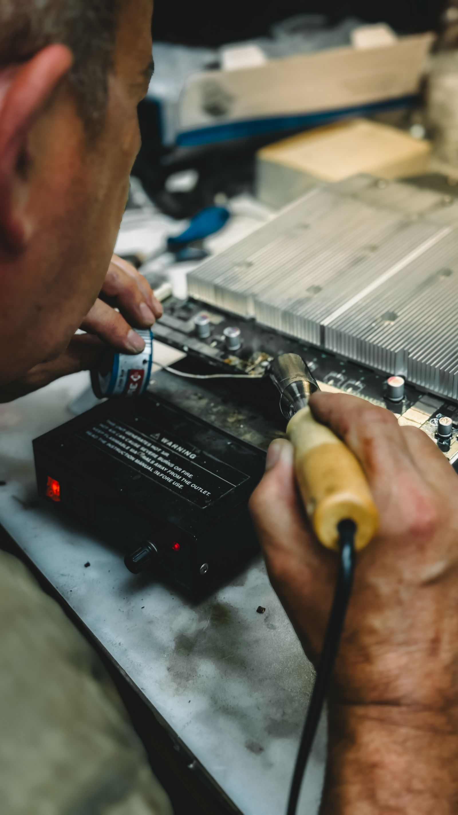 Sony TV repair technician soldering a circuit board — service in Mumbai Suburban